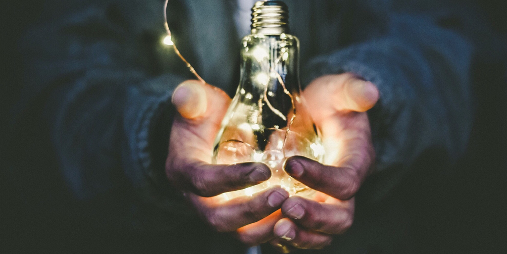 A man holding a light bulb