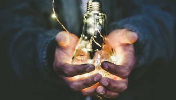 A man holding a light bulb