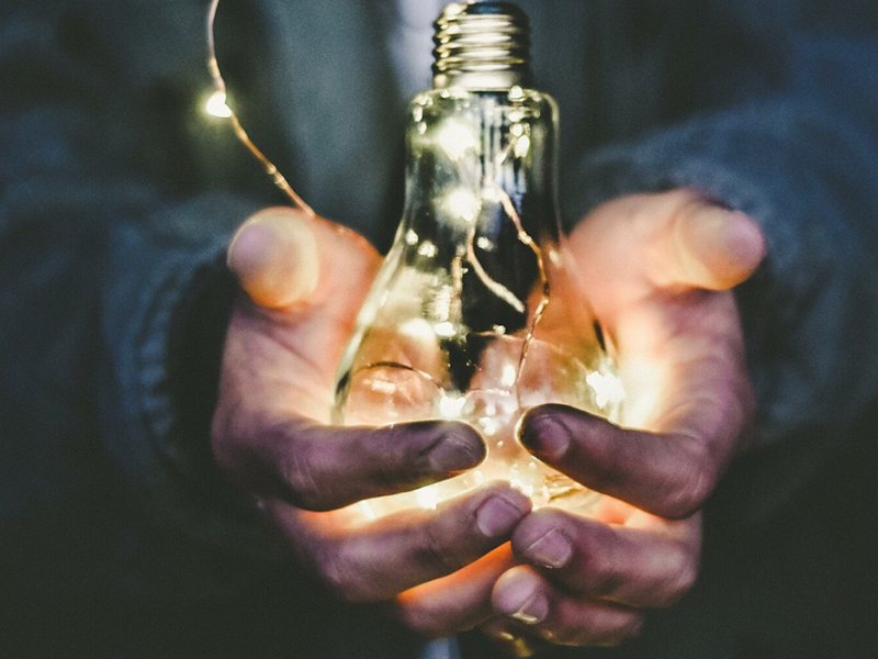 A man holding a light bulb