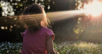 Child looking into the sun 