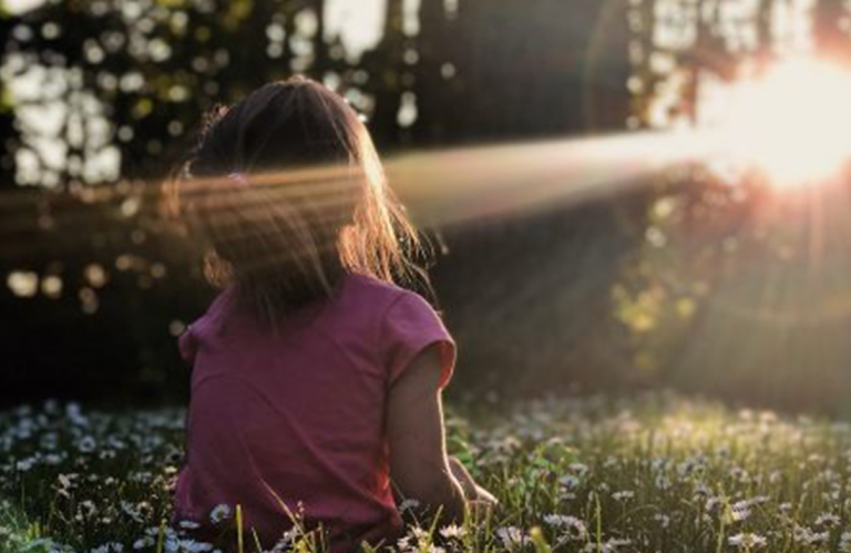 Child looking into the sun 